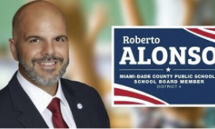 School Board member Roberto J. Alonso celebrates school board approval of two construction companies for gob projects totaling $37.5 million