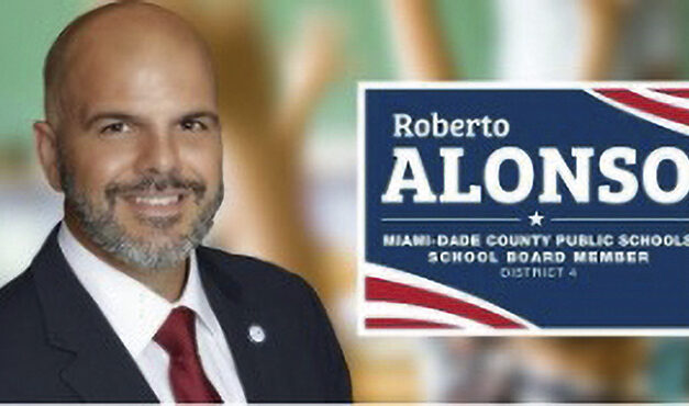 School Board member Roberto J. Alonso celebrates school board approval of two construction companies for gob projects totaling $37.5 million